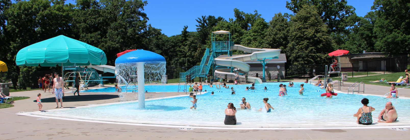 Swimmers at Bever Pool with the waterslide in the background