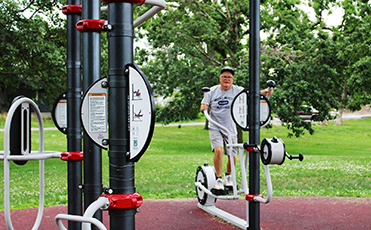 Man using outdoor exercise equipment 