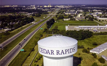 A water tank marked with the words Cedar Rapids cuts across an empty sky