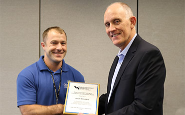 Utilities Director Steve Hershner presents the Laboratory Analyst Excellence Award to Jacob Donaghy.